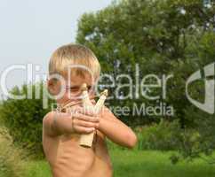 Child with a slingshot.