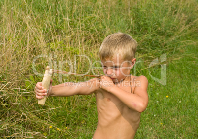 Child with a slingshot.