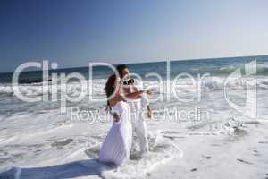 young couple at the beach in water