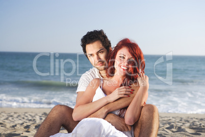 Couple at the beach seducing each other