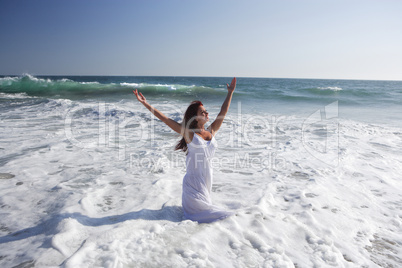 Young woman at the beach in water