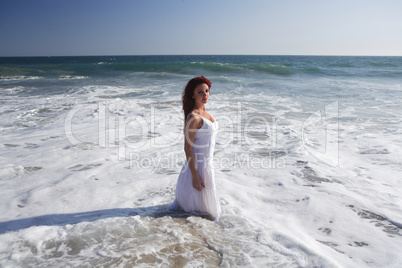 Young woman at the beach in water.