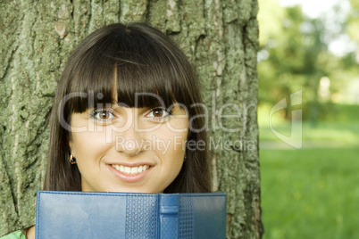 Female in a park with a notebook