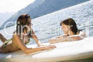 Girls relaxing on surfboard