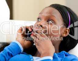 Astonished afro-american teenager talking on phone