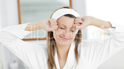 Beautiful woman stretching while standing in the bathroom