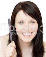 Portrait of an animated young woman holding a nail file