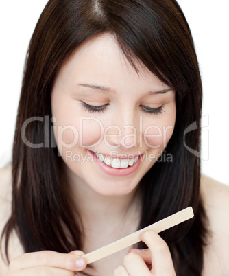 Portrait of a beautiful woman filing her nails