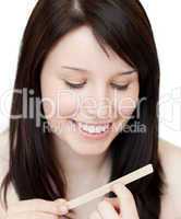 Portrait of a beautiful woman filing her nails
