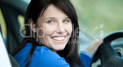 Bright female driver sitting in a car
