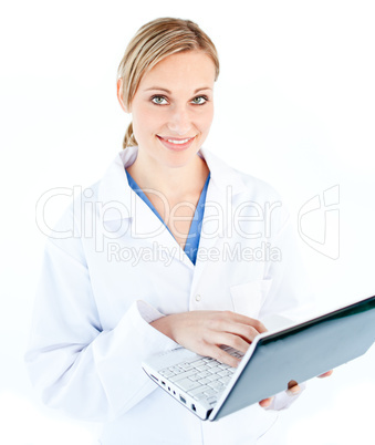 Charming female doctor holding a laptop looking at the camera