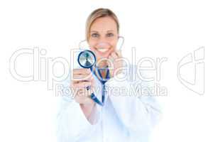 Glowing young doctor holding a stethoscope
