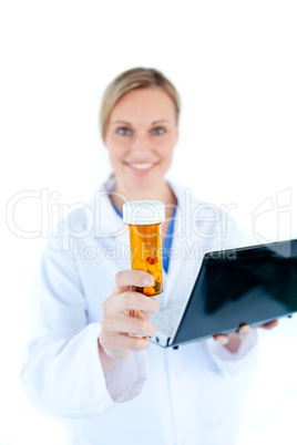 Charesmatic female doctor holding a laptop and pills