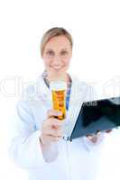 Charesmatic female doctor holding a laptop and pills