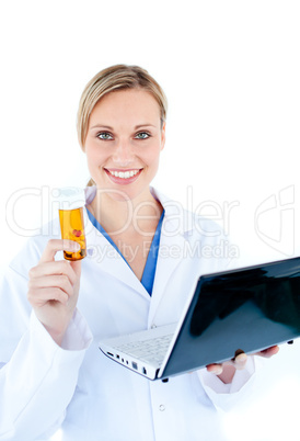 Smiling young doctor holding a laptop and pills