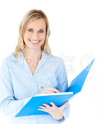 Charming businesswoman holding a folder smiling at camera