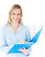 Charming businesswoman holding a folder smiling at camera