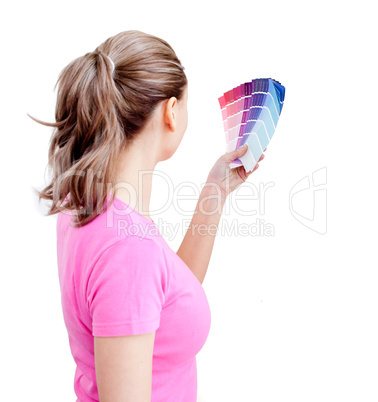 Blond young woman choosing colours in her living-room