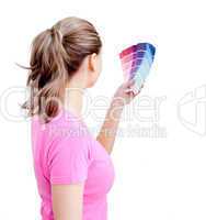 Blond young woman choosing colours in her living-room