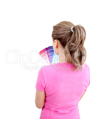 Thoughtful young woman choosing colours in her living-room