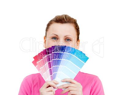 Cute caucasian woman behind color sample