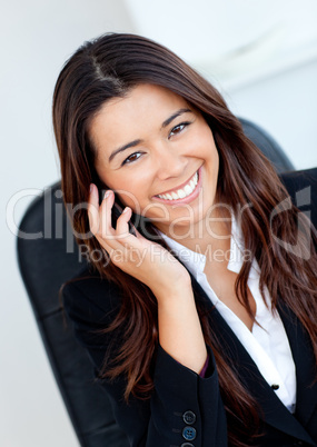 Jolly asian businesswoman talking on phone