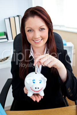 Positive caucasian businesswoman holding piggybank