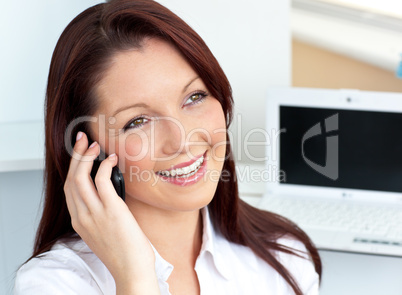 Cheerful businesswoman talking on phone