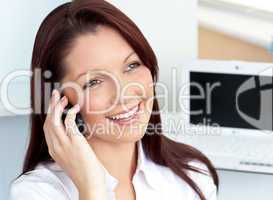 Cheerful businesswoman talking on phone