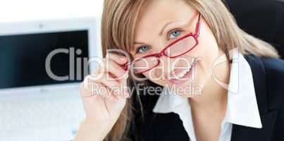 Charismatic businesswoman wearing glasses against white background