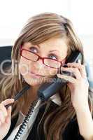 Pensive businesswoman talking on phone wearing glasses