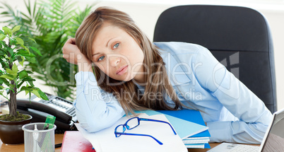 Bored businesswoman sitting at her desk