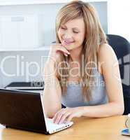 Beautiful woman using her laptop at home
