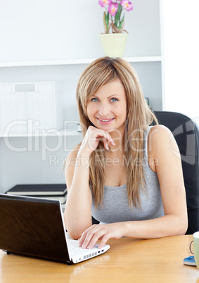Elegant woman using her laptop at home