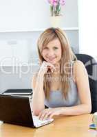Elegant woman using her laptop at home