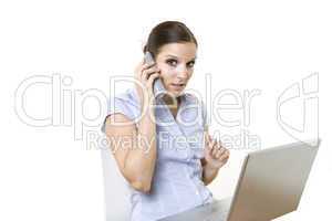 female on the phone in front of her computer