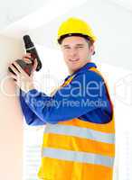 Attractive young worker holding a tool standing on a ladder