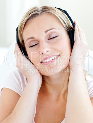 Radiant young woman listen to music wearing headphones