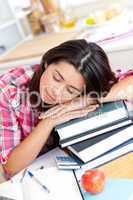 Tired asian student sleeping on her books