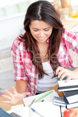 Frustrated asian student doing her homework