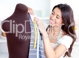 Glowing young woman working with clothes