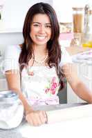 Bright asian woman baking in the kitchen