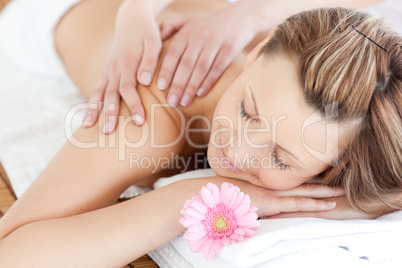 Delighted young woman receiving a back massage