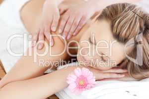 Delighted young woman receiving a back massage