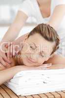 Smiling caucasian woman receiving a back massage