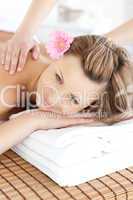 Beautiful young woman receiving a back massage