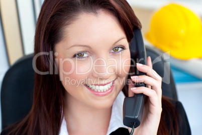 Smiling female architecture talking on phone