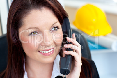 Self-assured female architecture talking on phone