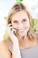 Beautiful caucasian woman talking on phone smiling at the camera