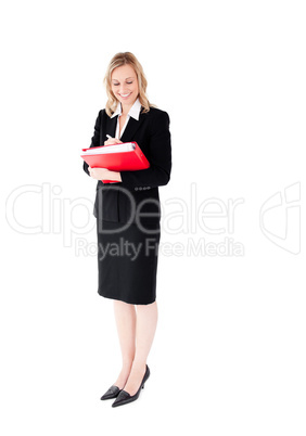 Confident businesswoman writing on a folder